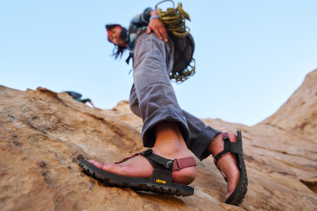 Person rock climbing wearing Bedrock Sandals Mountain Clogs in Leather Suede colorway