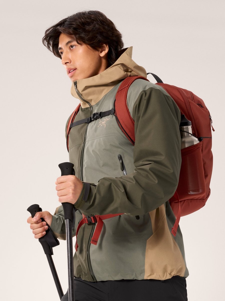 Arc'teryx Beta Jacket Men's in Forage-Tatsu colorway with hiking backpack and trekking poles