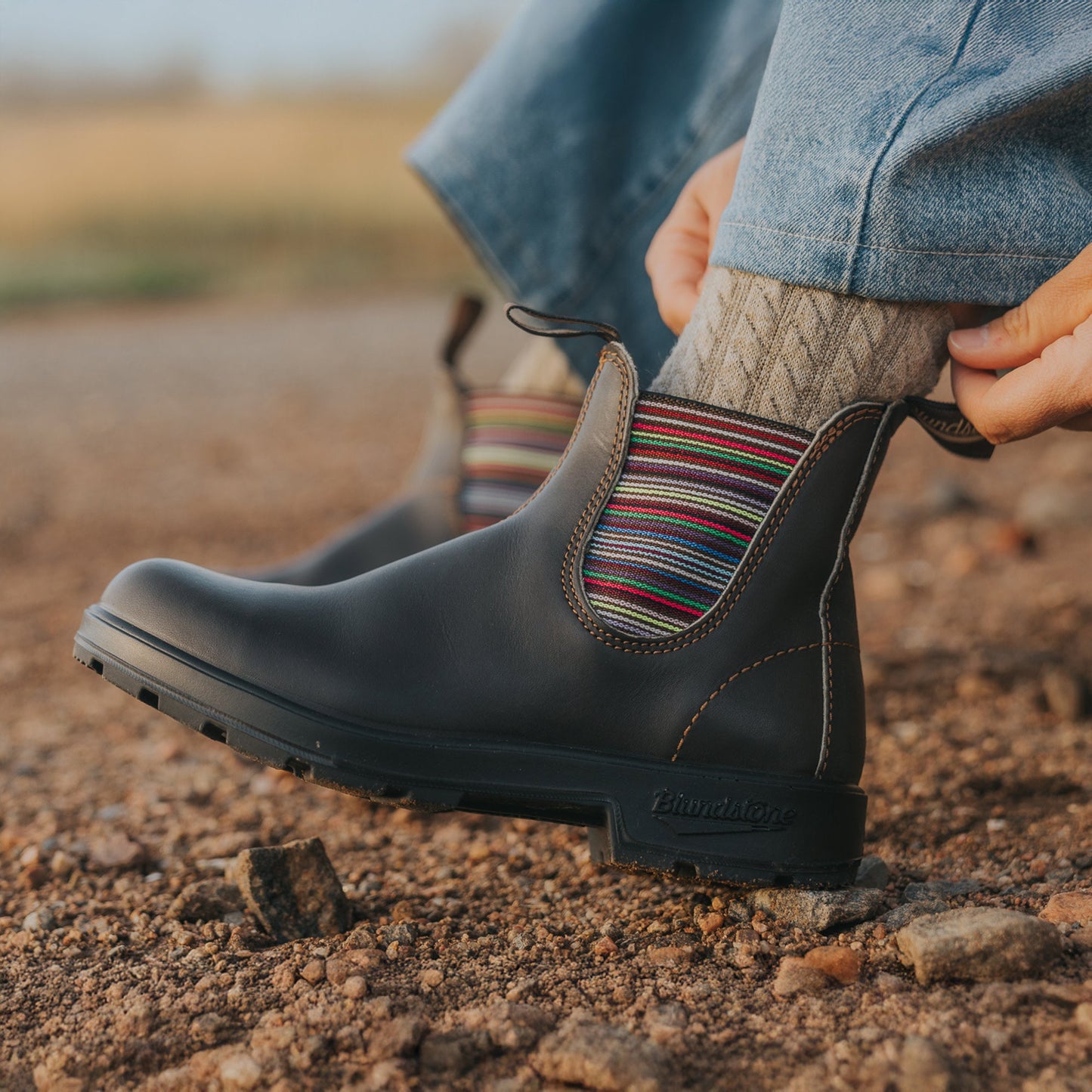 Blundstone #1409 brown leather Chelsea boot with multicolored striped elastic panel worn outdoors